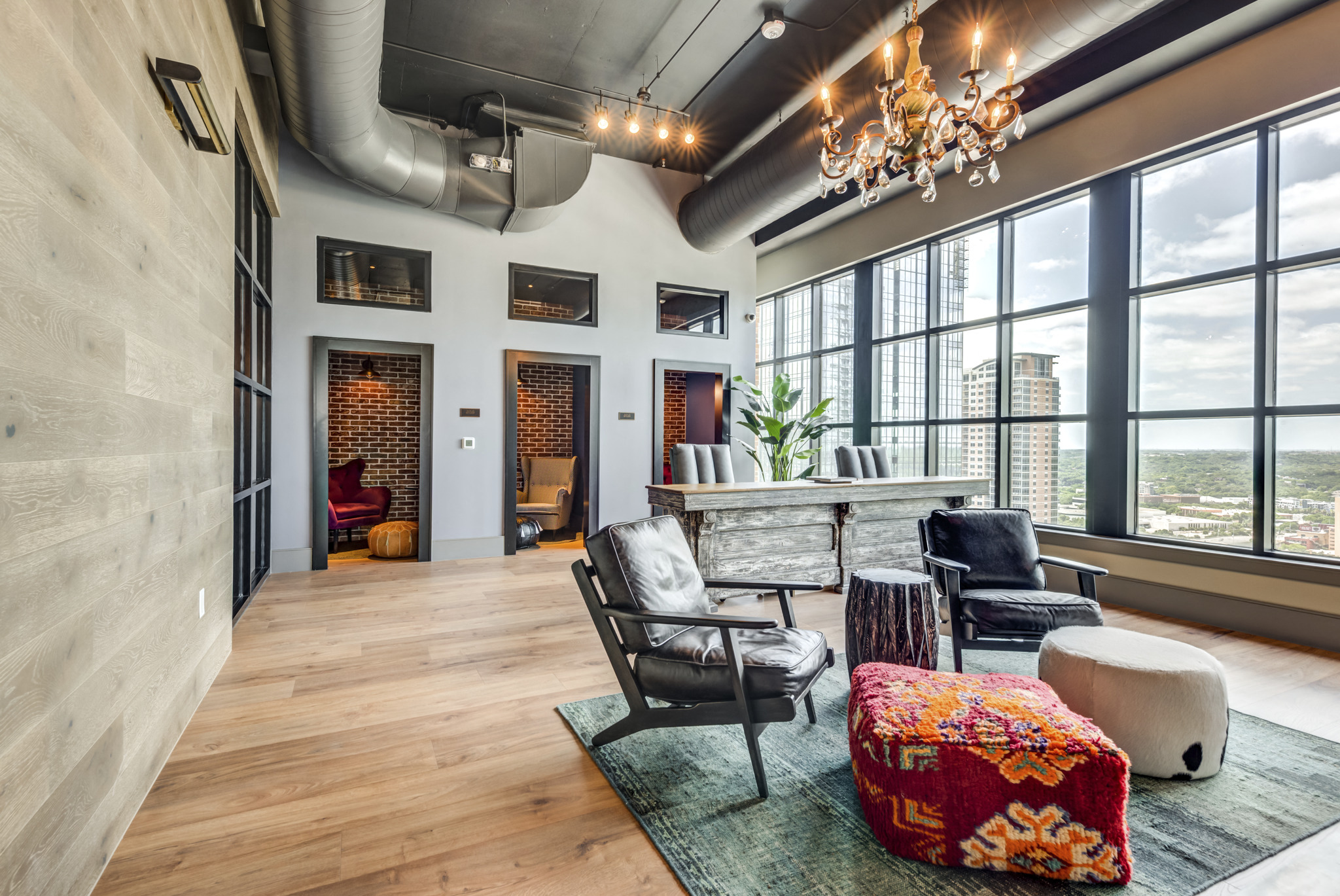 a living room with a table and chairs and a large window